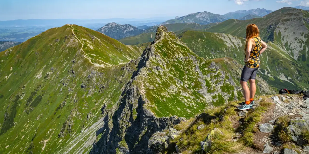 Widok na zielone szczyty Tatr Zachodnich na Słowacji. Kobieta podziwia panoramę gór.