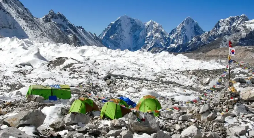 Namiotowe miasteczko na lodowcu, część trasy na Mount Everest. W tle ośnieżone szczyty.